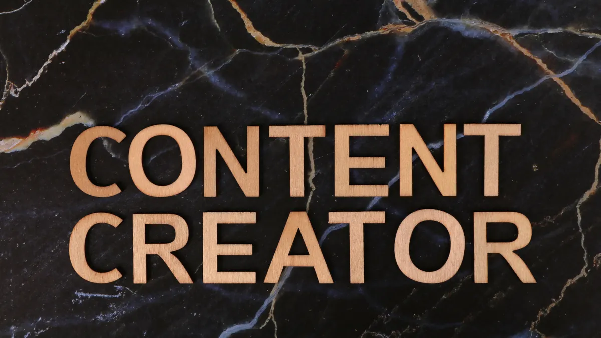 Jasper AI alternatives for content repurposing — Content Creator Wooden Text on Marble Background