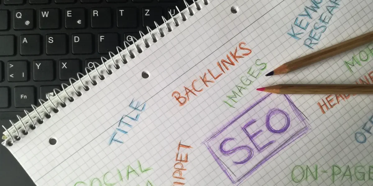 Notebook with SEO keywords and backlinks written around a central SEO box
